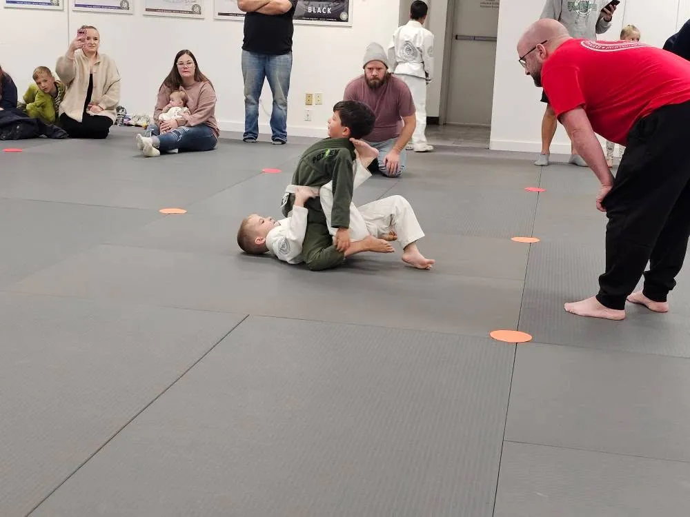 An adult demonstrating a takedown during Teen and Adult Jiu-Jitsu class